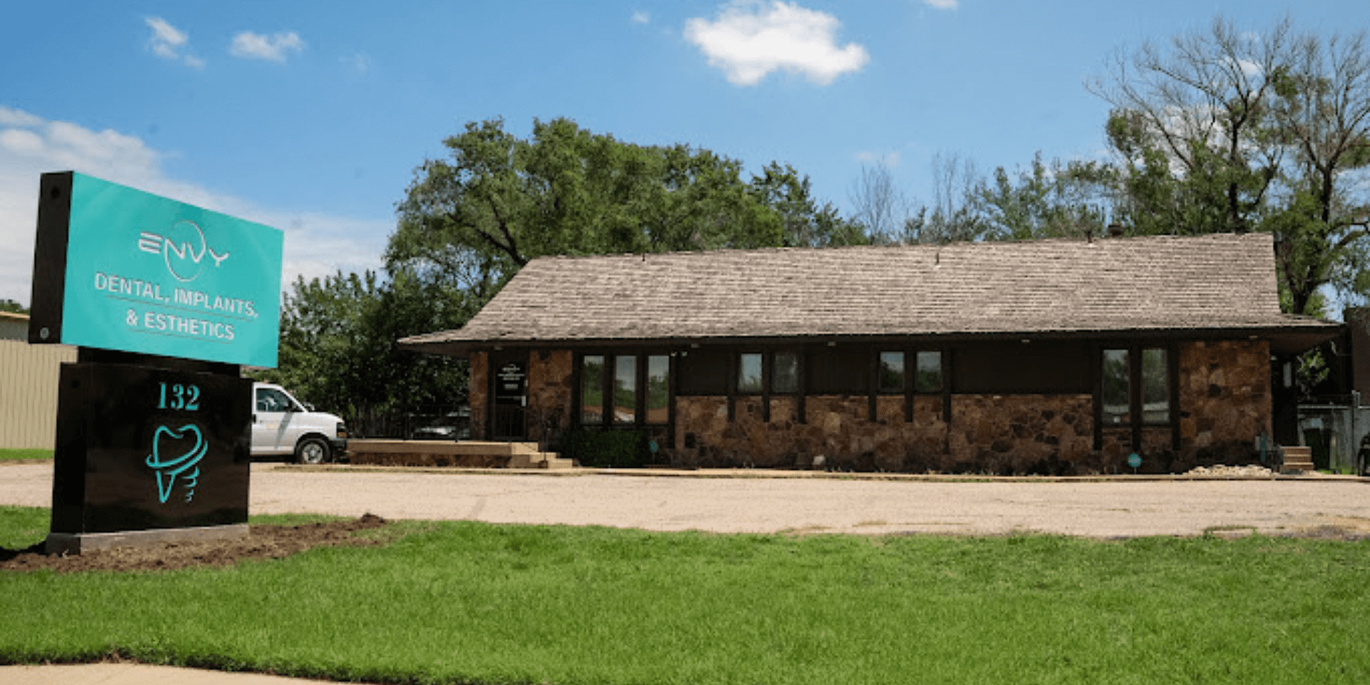 Front view of Envy Dental office in Wichita, KS with the Envy Dental, Implants & Esthetics sign