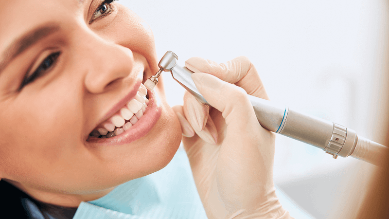 Close-up of a patient receiving a professional teeth cleaning at the dentist